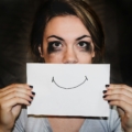 A person holding white printer paper. Overcoming Burnout: Rediscovering Joy in Your Work - Mania Work