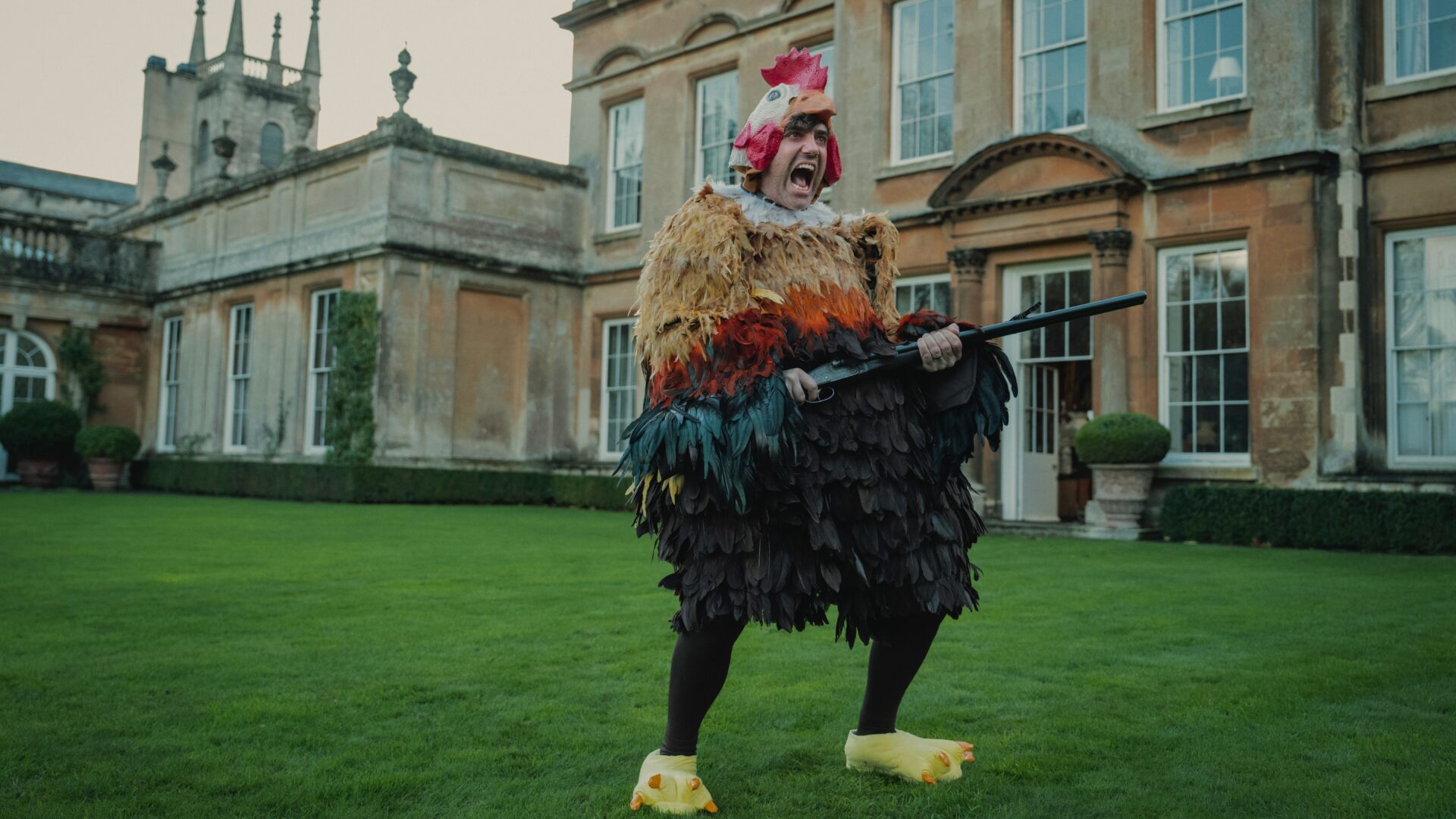 The Gentlemen (2024 TV Series) – A Stylish Crime Caper That’s More Than Just a Spin-Off 3 | Mania Africa | maniainc.com An Unhinged Freddy dressed up as a chicken in The Gentlemen (2024) Series - TV Series Reviews on Mania Movies