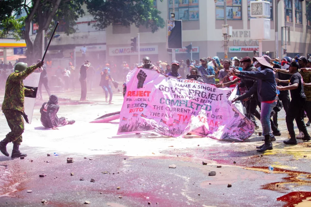 Mashujaa Day 2024: Remembering the 61 Fallen Gen Z Heroes Killed During the June Protests 2 | Mania Africa | maniainc.com A police officer facing off with Gen Z protests in June - Mashujaa Day 2024 - Remembering the 61 Fallen Gen Z Heroes Killed During the June Protests