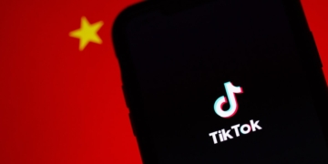 A TikTok app on a phone infront of the Chinese flag