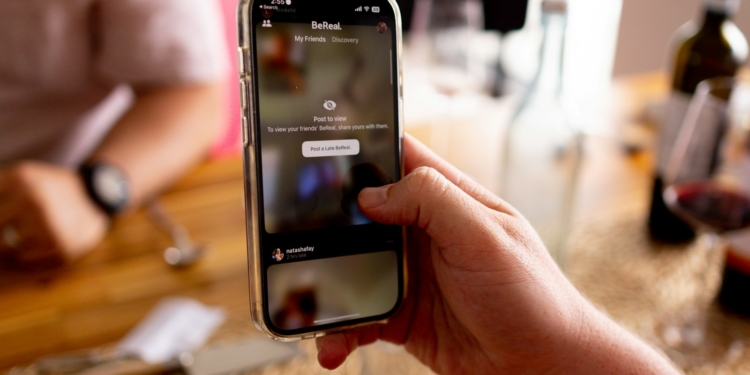 A phone showing the TikTok App with content censored - Unveiling TikTok's Alleged Anti-Trump Censorship – What Users Need to Know