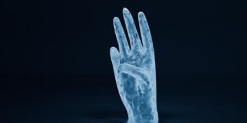 A hand emanating from darkness - AI's Hidden Human Cost: The Struggle of Kenya's Data Workforce - Mania Tech