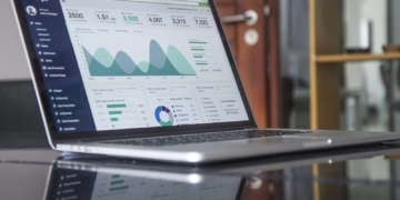 laptop computer on glass-top table - Maximize ROI for your SMB Website with Cloudways' CPU-Optimized Servers + Lightning Stack: Scale for Long-term Growth at an Affordable Price