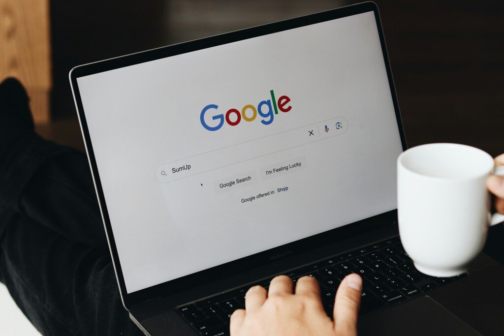 Why Google's Gemini 3.5 Pro Is Facing Delays: Inside the AI Giant's Biggest Challenge Yet—and Why OpenAI and Anthropic Are Pulling Ahead in the Agentic Coding Race 4 | Mania Africa | maniainc.com A person sitting in front of a laptop computer using Google Search - Google's Internal Challenges: Can a Company This Big Still Move Fast When It Comes to AI Development?