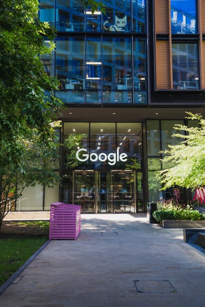 Why Google's Gemini 3.5 Pro Is Facing Delays: Inside the AI Giant's Biggest Challenge Yet—and Why OpenAI and Anthropic Are Pulling Ahead in the Agentic Coding Race 3 | Mania Africa | maniainc.com a purple chair sitting in front of a Google building - Reports of Gemini 3.5 Pro Delays Have Intensified Scrutiny