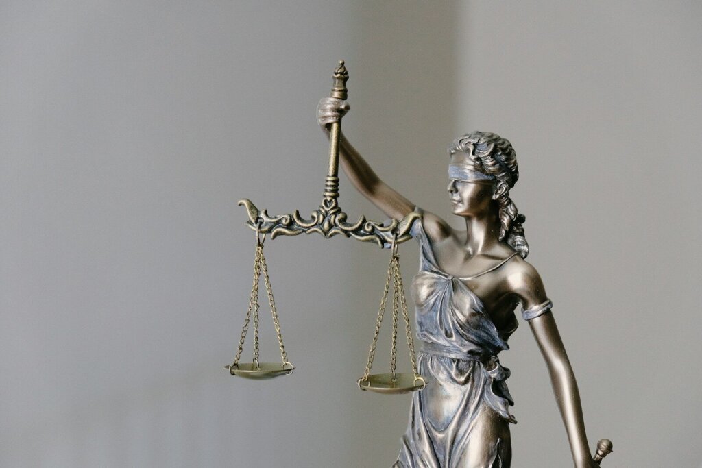 Why Google's Gemini 3.5 Pro Is Facing Delays: Inside the AI Giant's Biggest Challenge Yet—and Why OpenAI and Anthropic Are Pulling Ahead in the Agentic Coding Race 6 | Mania Africa | maniainc.com lady justice statue with scales and sword - Regulatory Pressure, Investor Expectations, and the Future of Google's AI Strategy