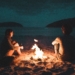 How to Move On After a Breakup When You Still Love That Person: A Comprehensive Guide to Healing and Letting Go 19 | Mania Africa | maniainc.com A man and woman sitting near a fire by the beach