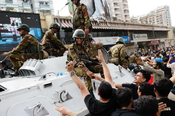 Political Earthquake Rocks Bangladesh: The Aftermath of PM Sheikh Hasina's Shocking Resignation and Exile 13 | Mania Africa | maniainc.com Bangladeshi youth greeting military officers following the shocking resignation of PM Hasina | Sheikh Hasina Resigns: What’s Next for Bangladesh? | Mania Politics
