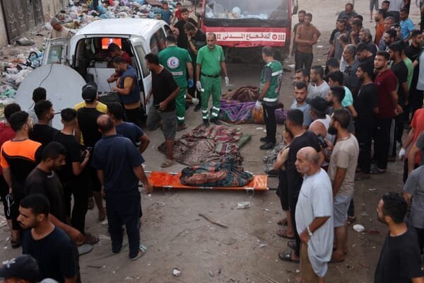Behind the Carnage: Israeli Attack on Gaza School Claims Over 100 Lives 2 | Mania Africa | maniainc.com Rescue workers at Al-Tabi’in School | Israeli Attack on Gaza School Claims Over 100 Lives | Mania News