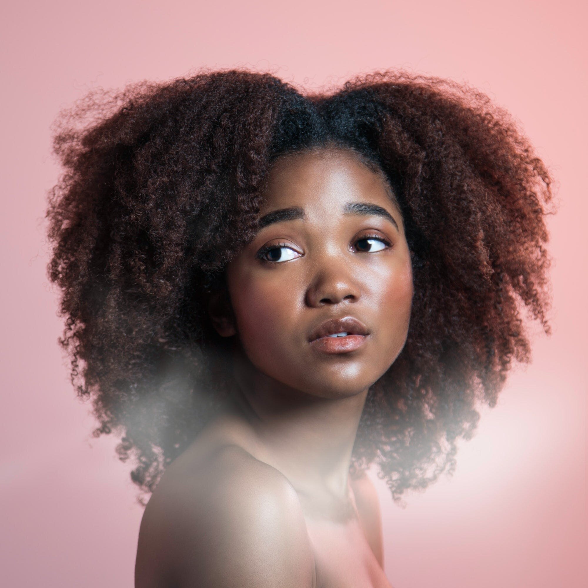 Unlock the Secret to Healthy and Shiny Locks: The Ultimate Hair Care Routine 3 | Mania Africa | maniainc.com A model with beautiful curly hair