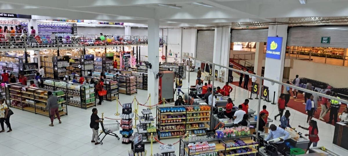 Chinese Supermarket China Square Kenya Reopens After Intervention by the KCCC 4 | Mania Africa | maniainc.com A pictue of the main doors of China Square from the inside where we can see shoppers paying for their products