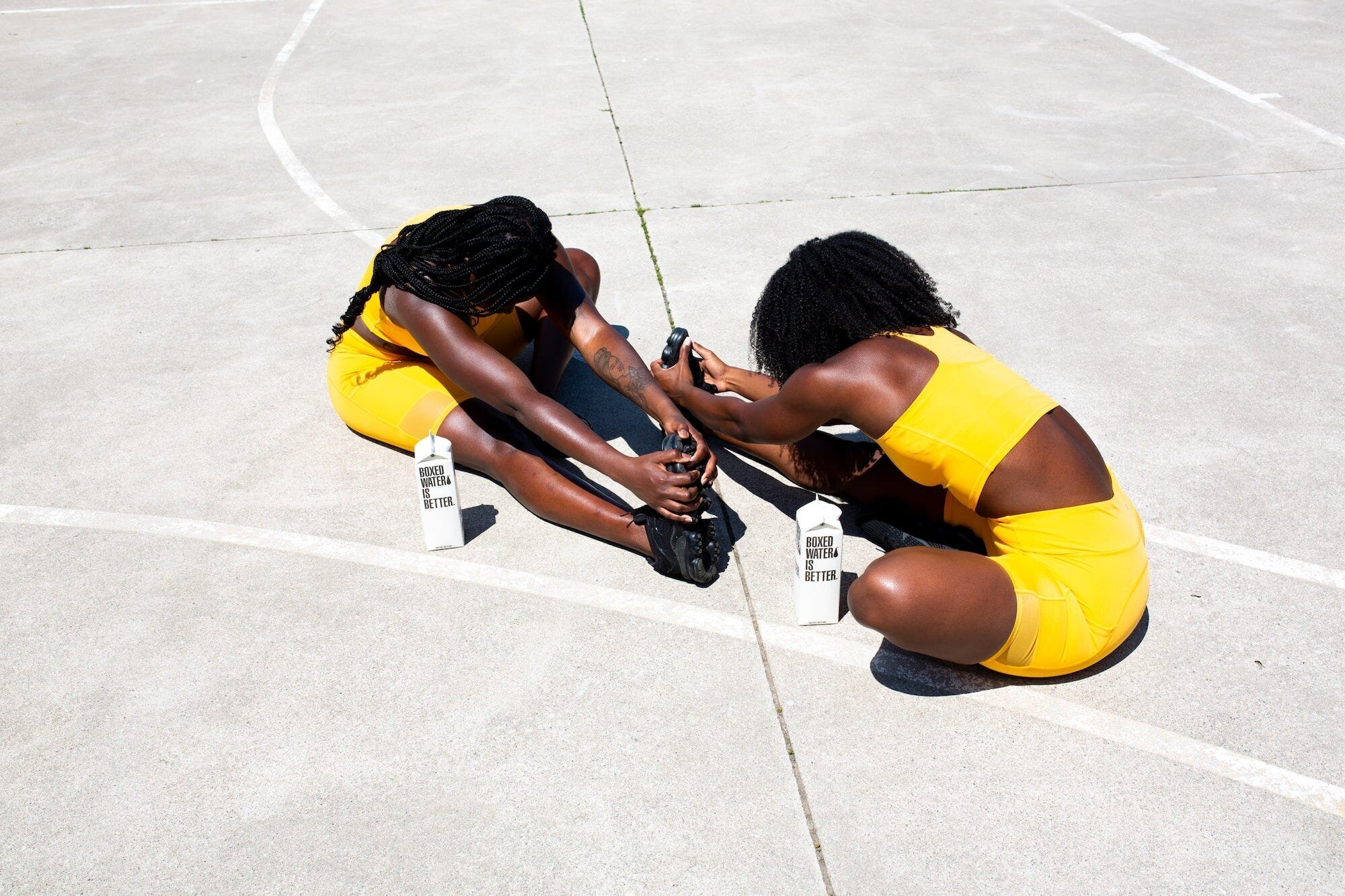 Unlock Your Gym Motivation: 7 Tips to Stay Happy and Energized During Workouts 2 | Mania Africa | maniainc.com A photo of two women in yellow gym clothes working out together