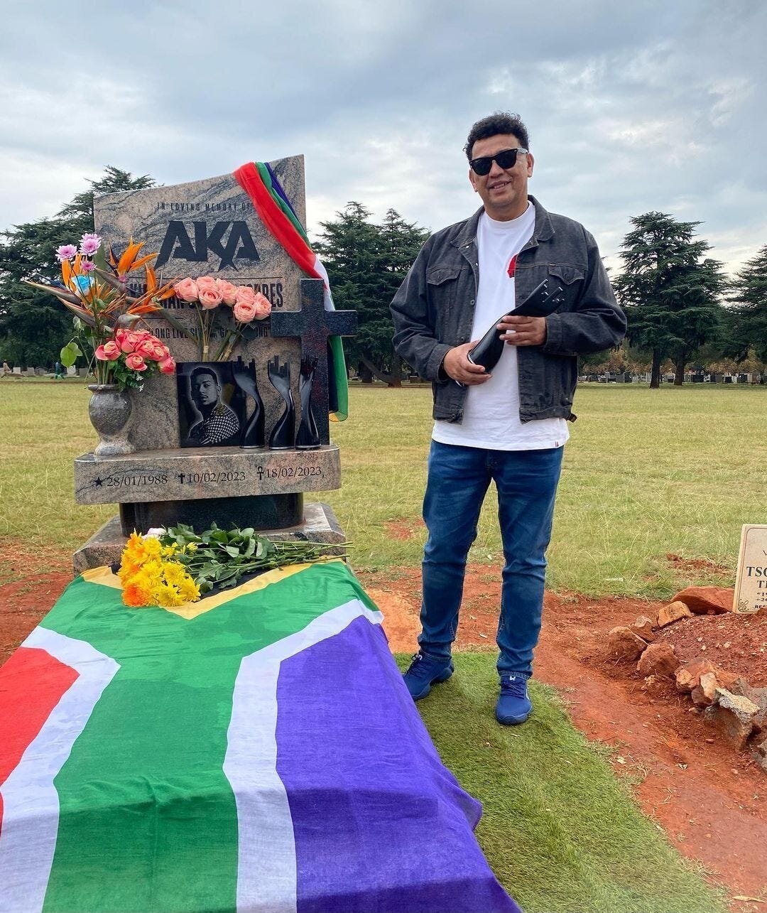 Late SA Rapper AKA Bags Four Posthumous Awards at the Metro FM Music Awards 4 | Mania Africa | maniainc.com AKA's dad standing by his late son's grave with an award
