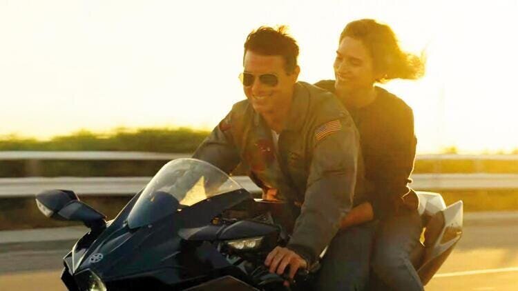 Top Gun: Maverick Movie Review 5 | Mania Africa | maniainc.com Mav and Penny riding on his bike in Top Gun: Maverick