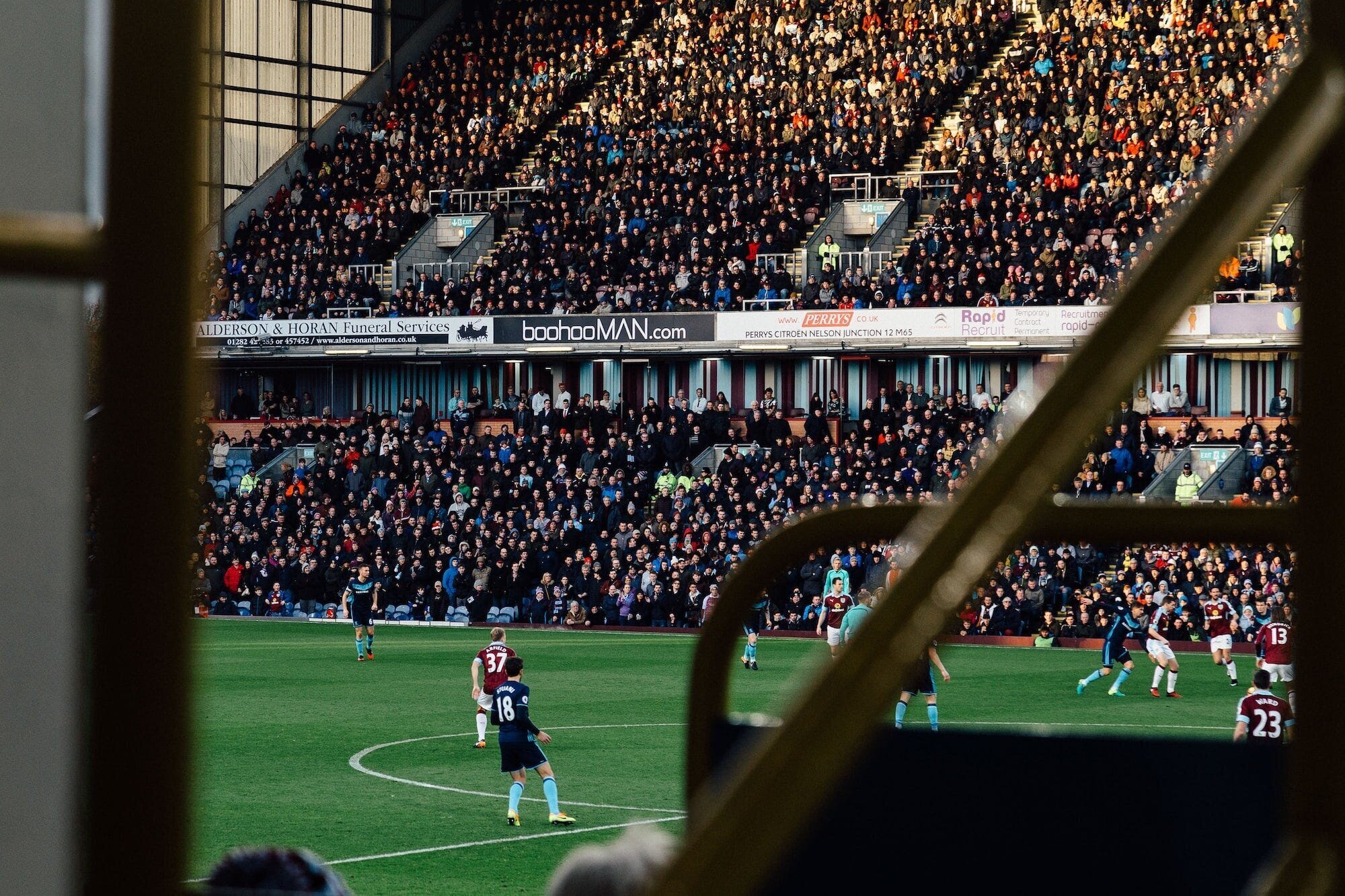 Premier League Promotion and Relegation: How Teams Climb the English Football Ladder 3 | Mania Africa | maniainc.com Players playing in the English Premier League from the view of a fan