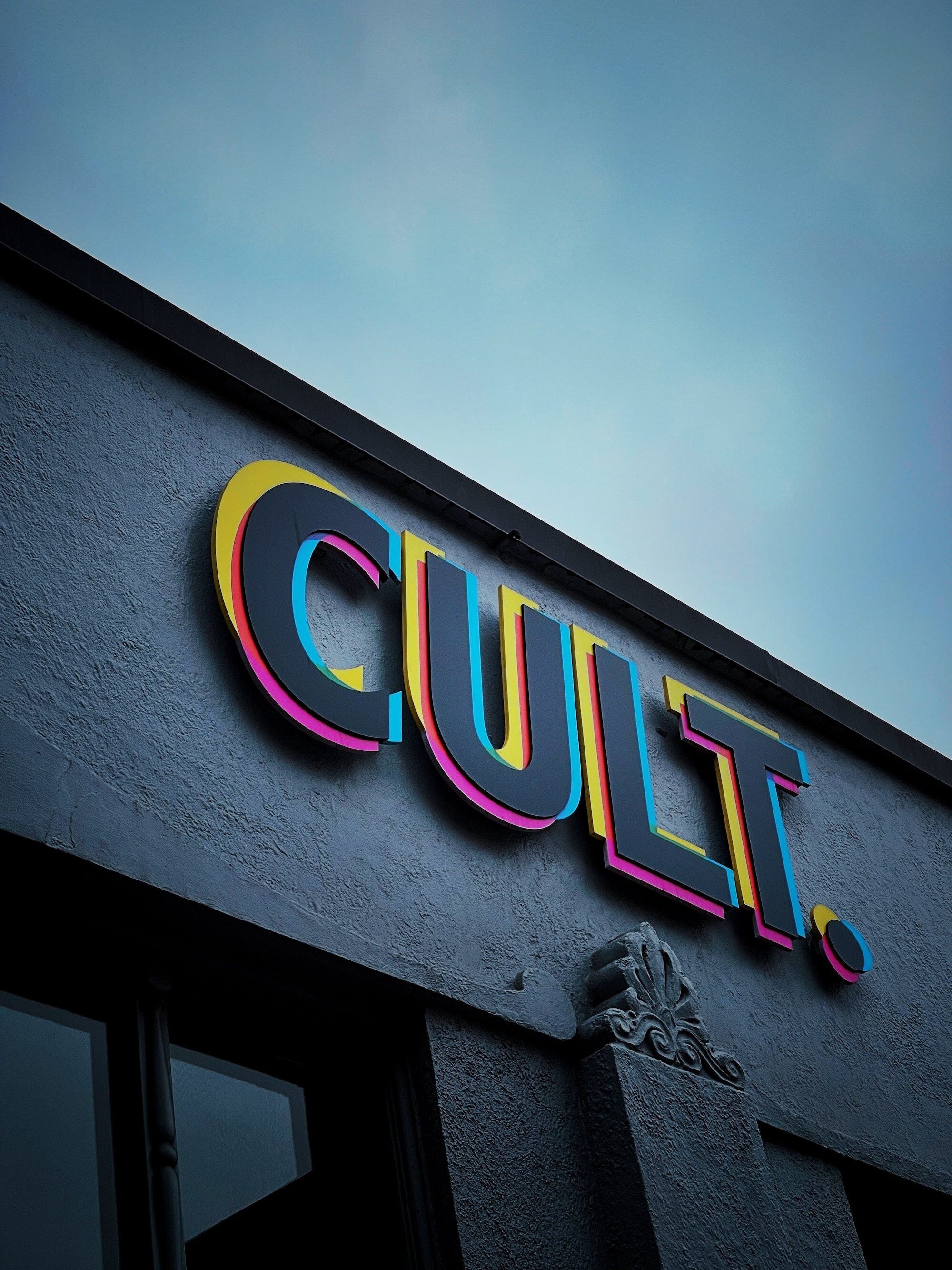 The Truth About Cults: How They Work, Why People Join, and How to Avoid Falling Victim 6 | Mania Africa | maniainc.com A sign reading 'Cult' on the side of a building