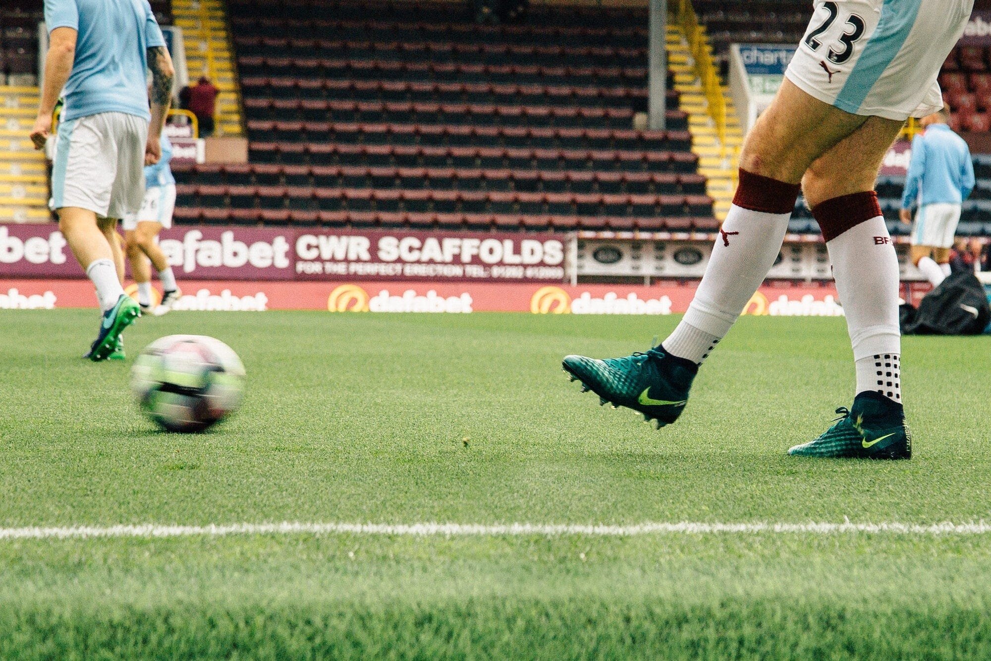 Premier League Promotion and Relegation: How Teams Climb the English Football Ladder 2 | Mania Africa | maniainc.com A Premier League footballer passing the ball