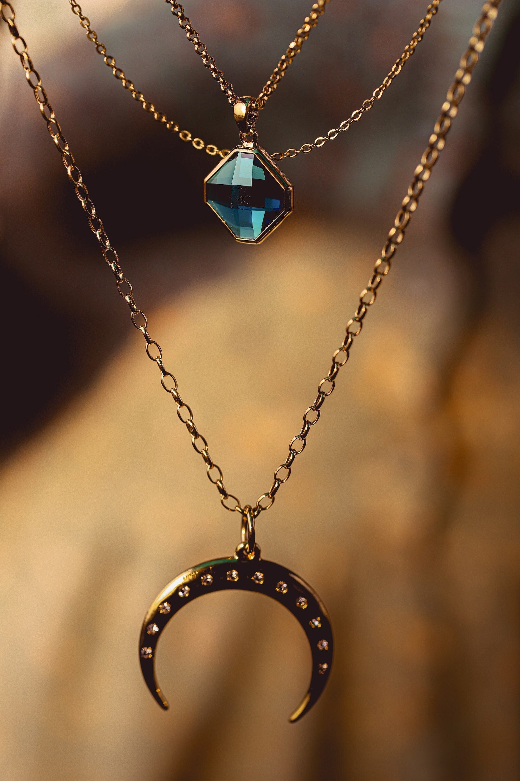 Fake Fashion: How to Spot Counterfeit Items and Avoid Being Scammed 5 | Mania Africa | maniainc.com A necklace jewelry piece with a blue stone and an upside down crescent moon
