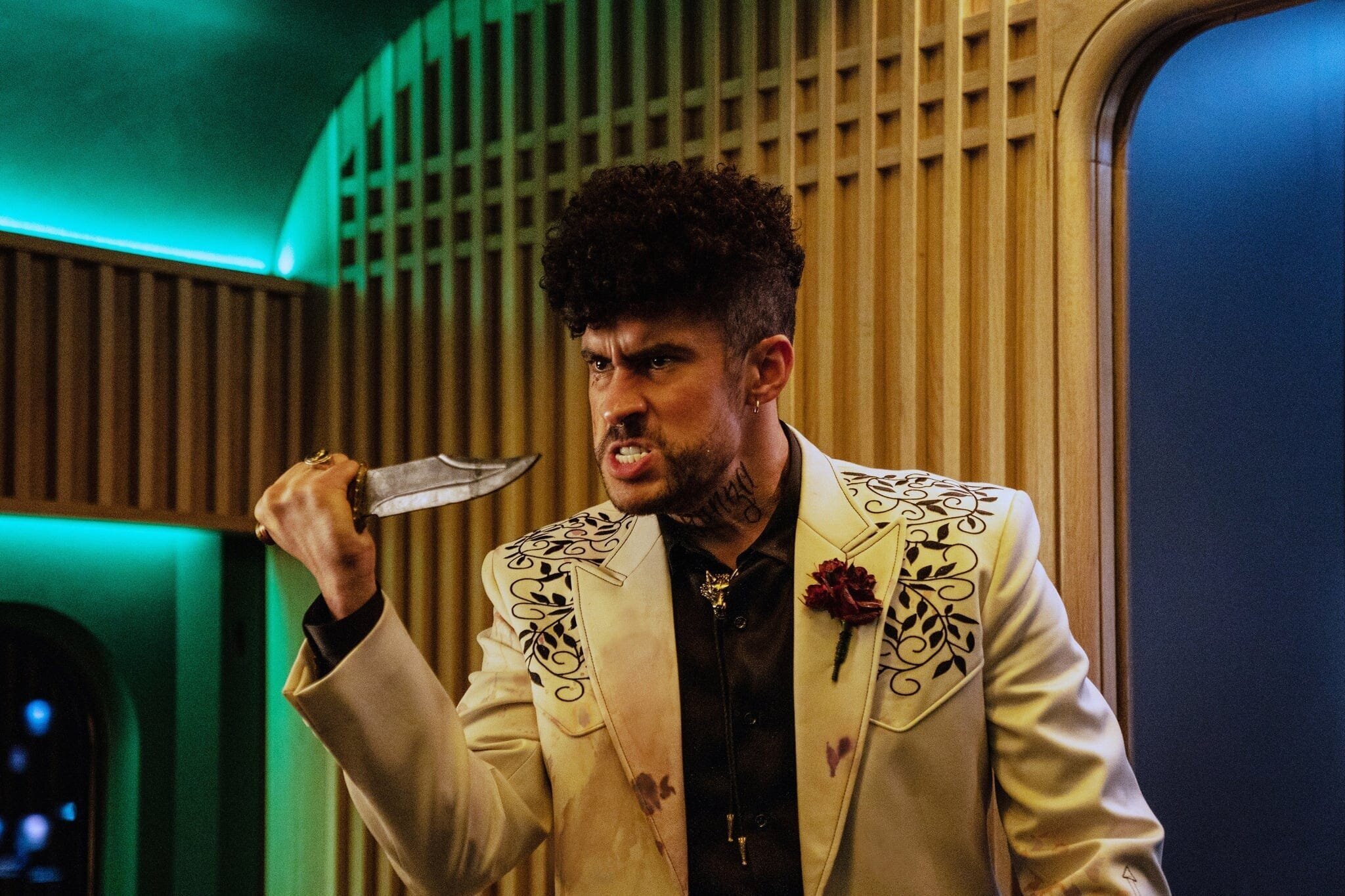 Bullet Train Movie Review 4 | Mania Africa | maniainc.com Bad Bunny playing The Wolf in Bullet Train with a knife in his hand