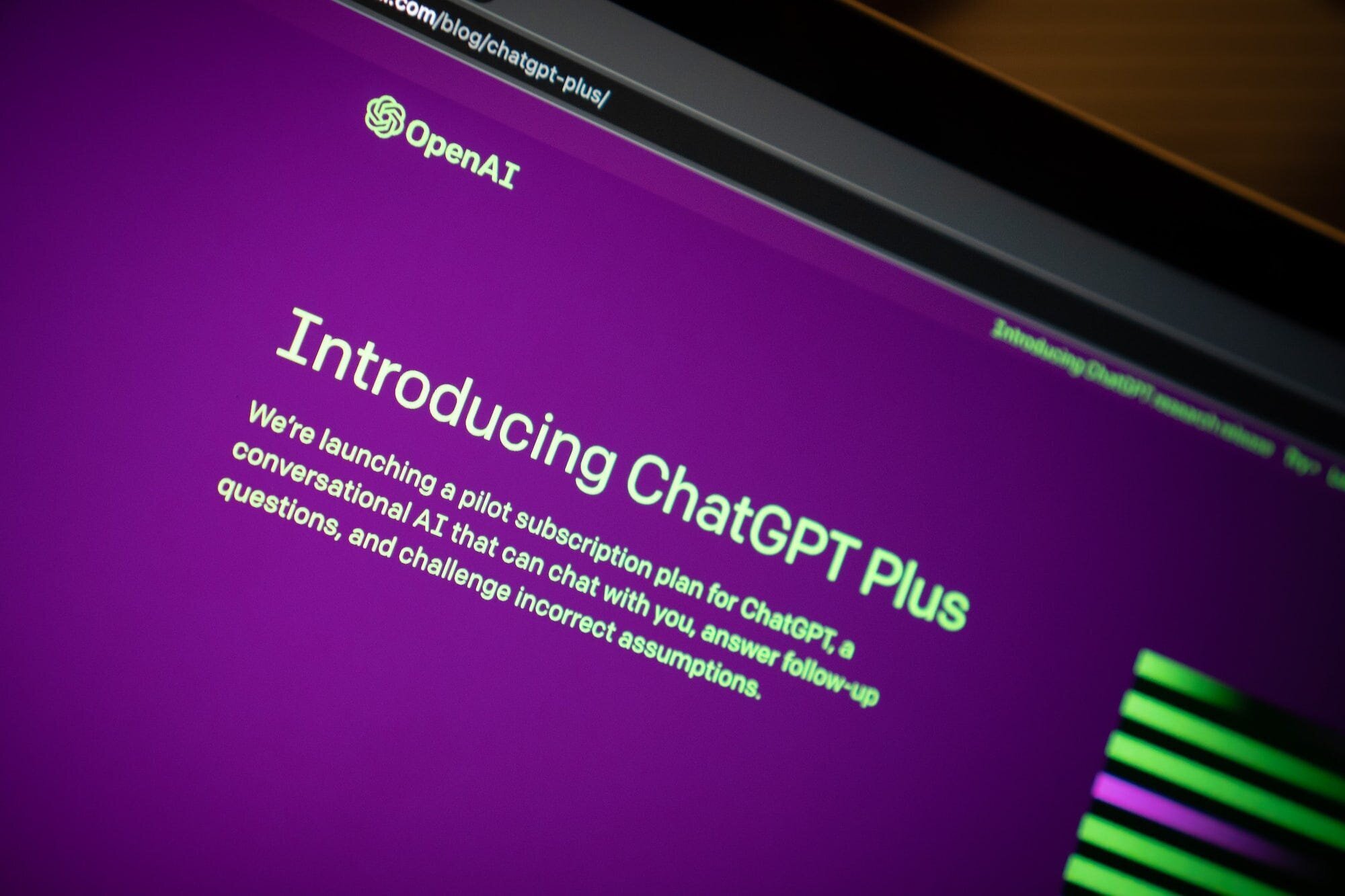 An image of a computer screen on OpenAI's website with the page reading 'Introducing ChatGPT Plus'