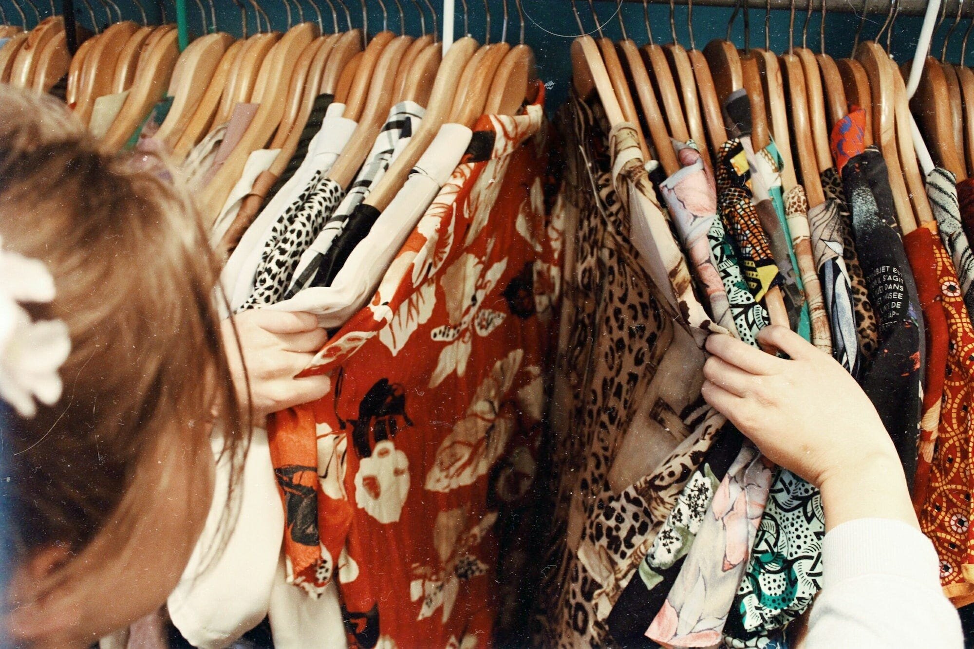 Stay Cozy and Stylish: Tips for Styling Your Outfits with Soft and Cozy Accessories 4 | Mania Africa | maniainc.com A woman shopping for clothes in a thrift store