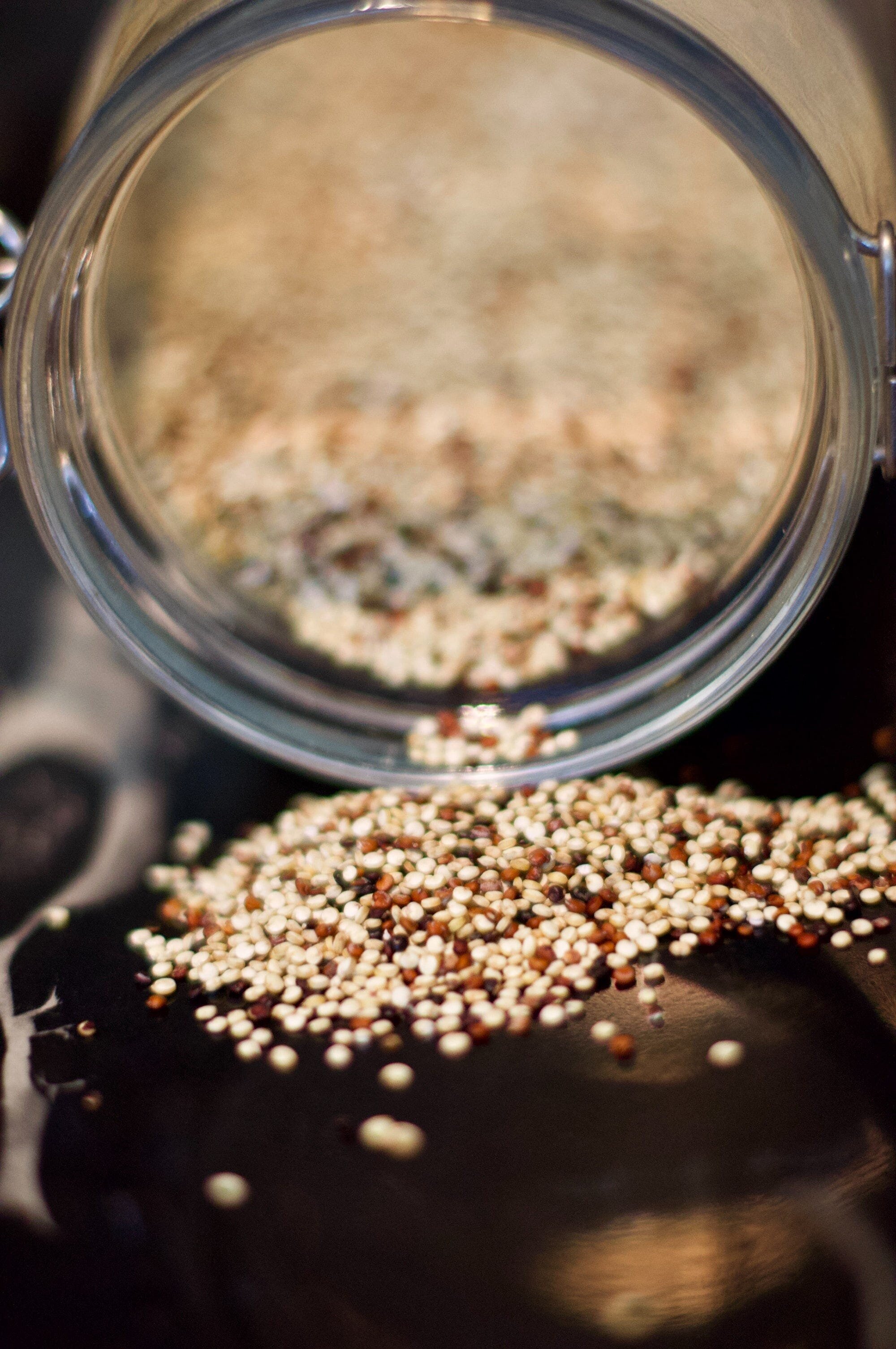 Protein Allergy? No Problem: Exploring the Best Alternative Sources of Protein for Your Diet 2 | Mania Africa | maniainc.com A jar of Quinoa seeds pouring the seeds onto a table