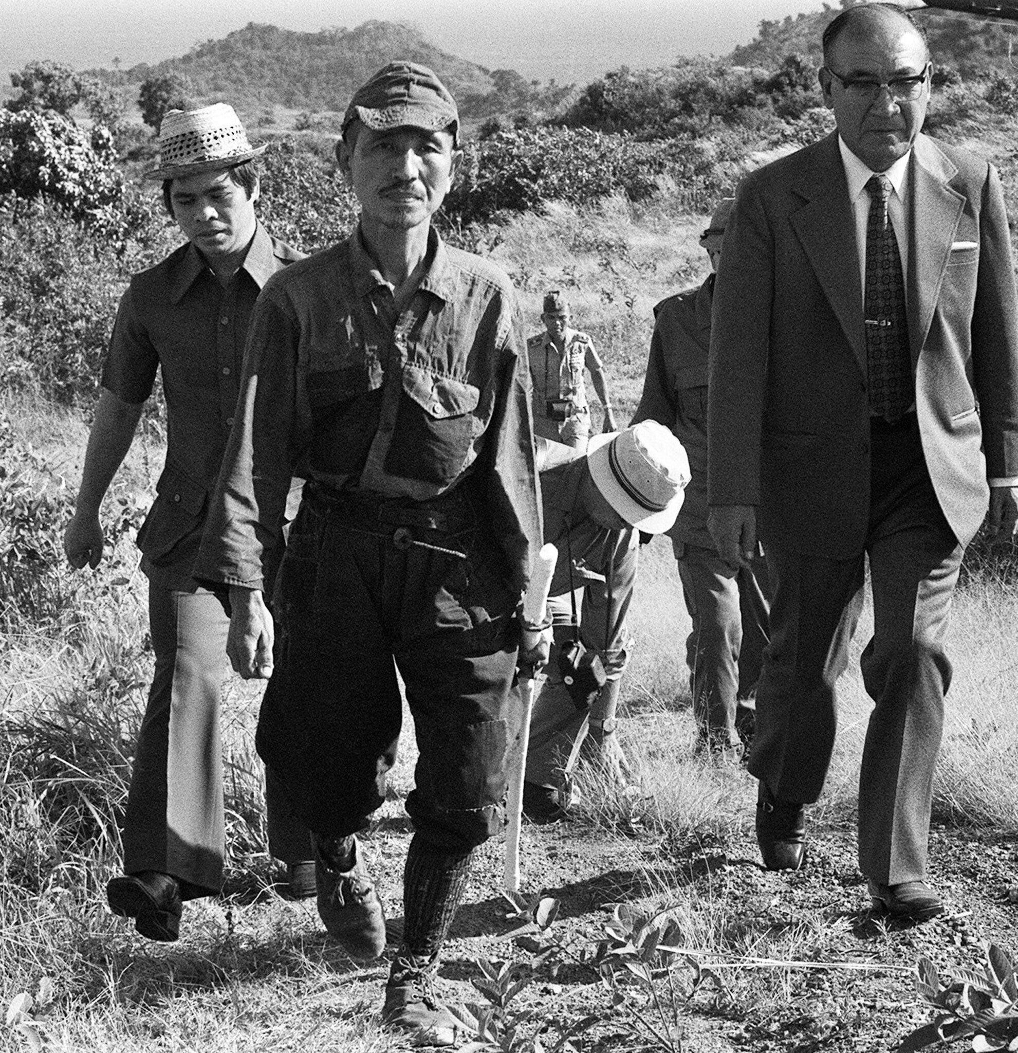 The Subtle Art of Not Giving a F*ck Documentary Review and Teachings 3 | Mania Africa | maniainc.com Hiroo Onoda alongside Norio Suzuki, an official and being followed by journalists after he was convinced to stop fighting