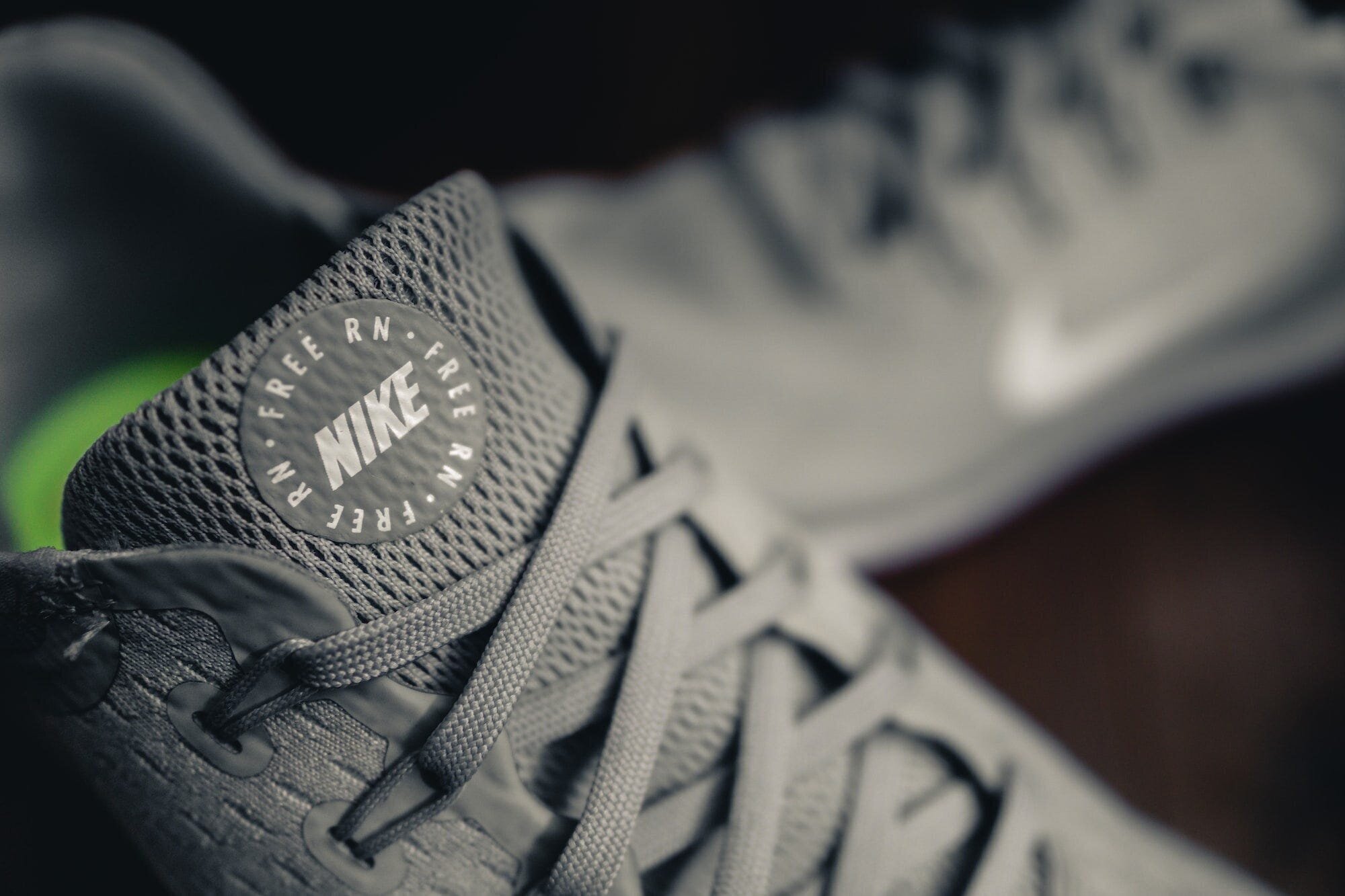 No More Hassle: The Ultimate Guide to Choosing and Wearing Laceless Shoes 7 | Mania Africa | maniainc.com A pair of laceless Nike running shoes in grey color and green inner sole