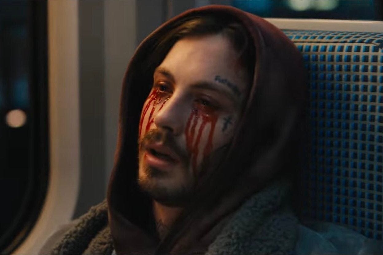 Bullet Train Movie Review 3 | Mania Africa | maniainc.com The White Death's son with his eyes bleeding after he is poisoned by The Hornet