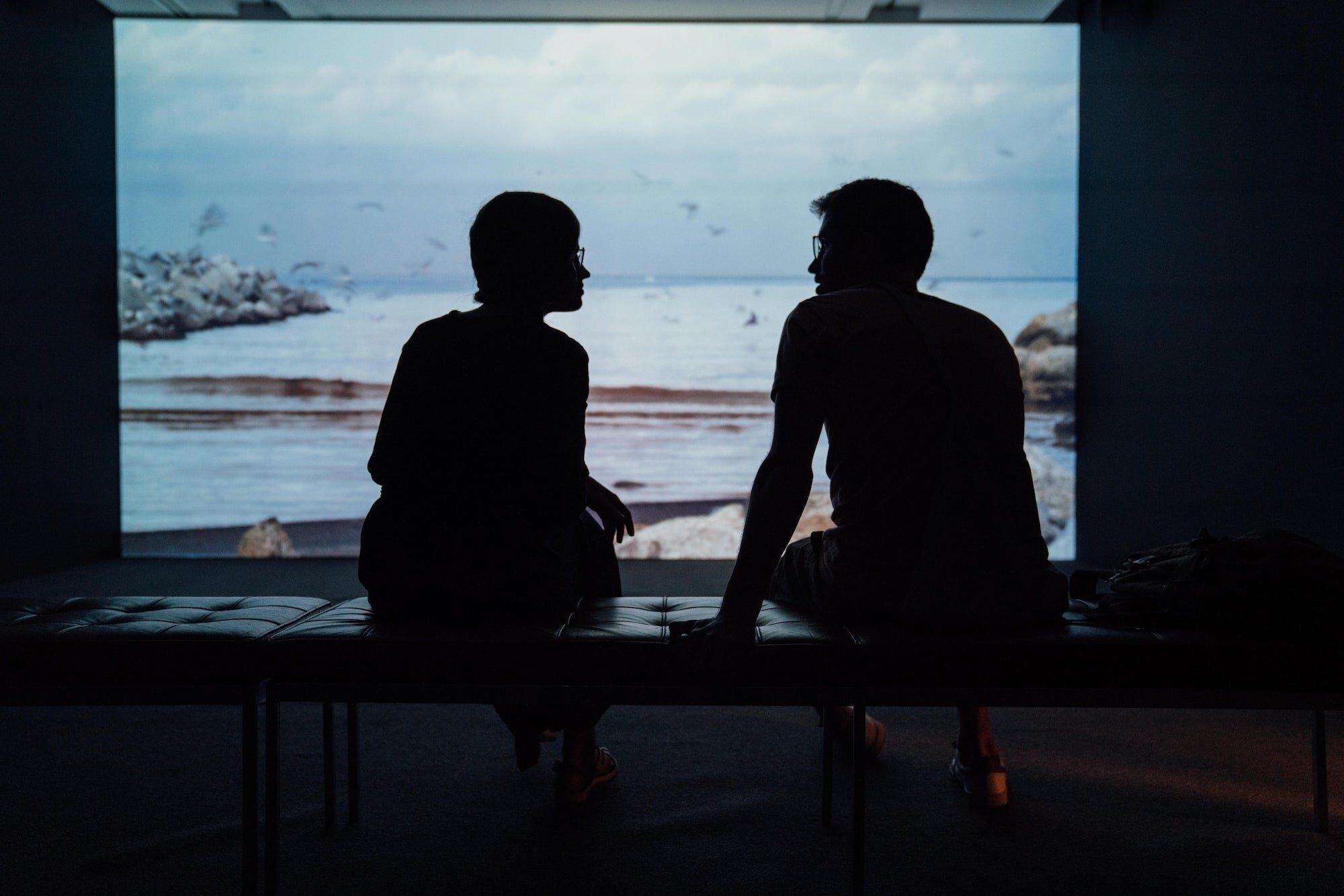 How to Move On After a Breakup When You Still Love That Person: A Comprehensive Guide to Healing and Letting Go 5 | Mania Africa | maniainc.com A man and woman sitting on a bench in an art exhibition