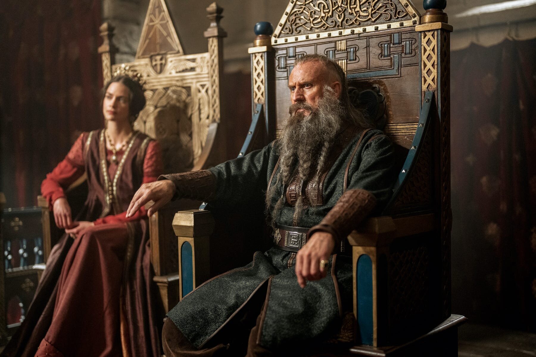 Vikings: Valhalla Season 1 Review 6 | Mania Africa | maniainc.com King Canute's father, Sweyn Forkbeard sitting on the English throne alongside Queen Emma of Normandy