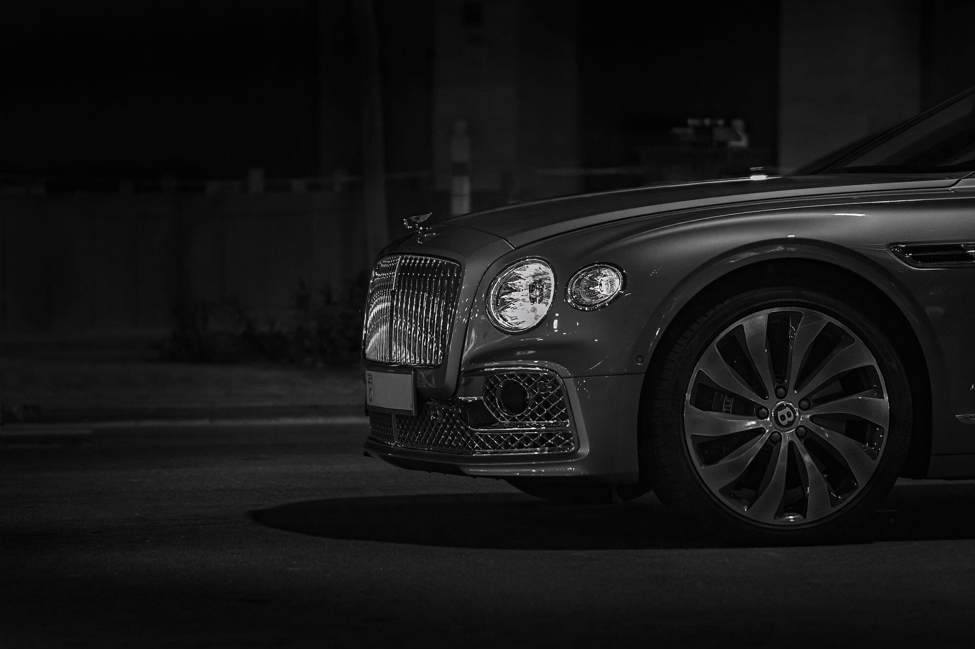 7 Tips for Buying a Luxury Car 5 | Mania Africa | maniainc.com A grey Bentley out at night with only the front part shown
