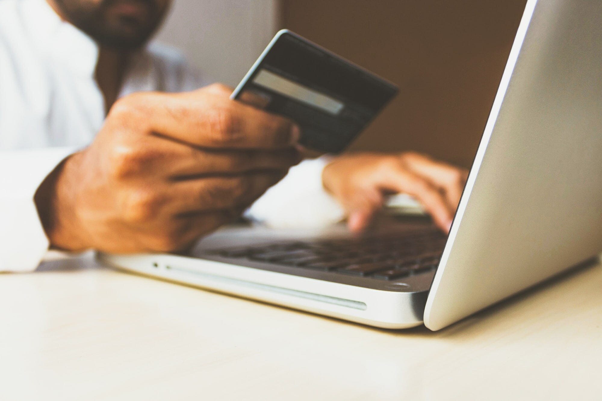 How to Get a Stripe Account in an Unsupported Country Using Stripe Atlas: A Guide for Creators 3 | Mania Africa | maniainc.com An image of a man keying in his credit card details on a laptop