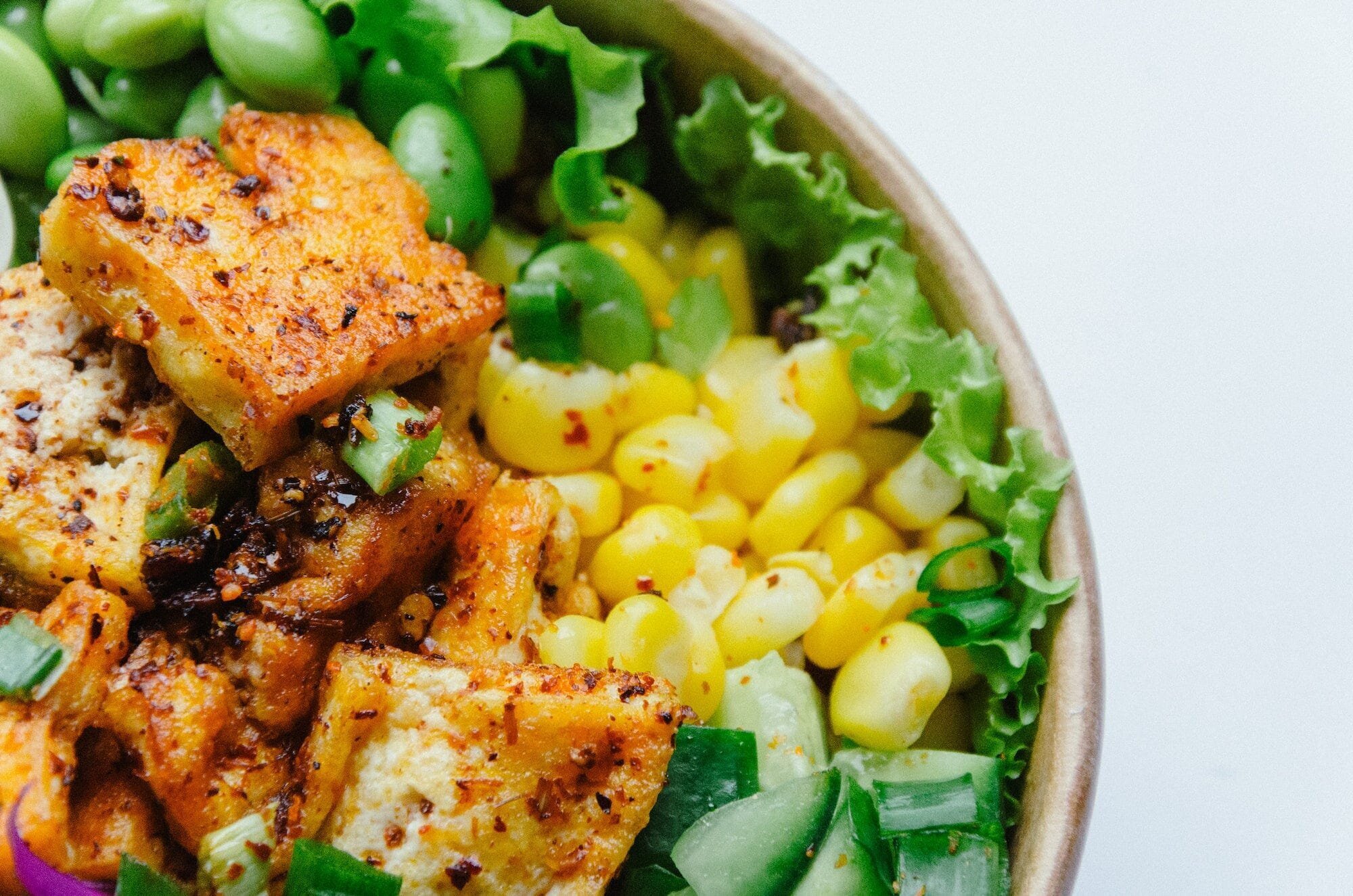Vegan Nutrition 101: How to Get All the Nutrients You Need on a Plant-Based Diet 2 | Mania Africa | maniainc.com A bowl containing tofu, corn, and other green vegetables
