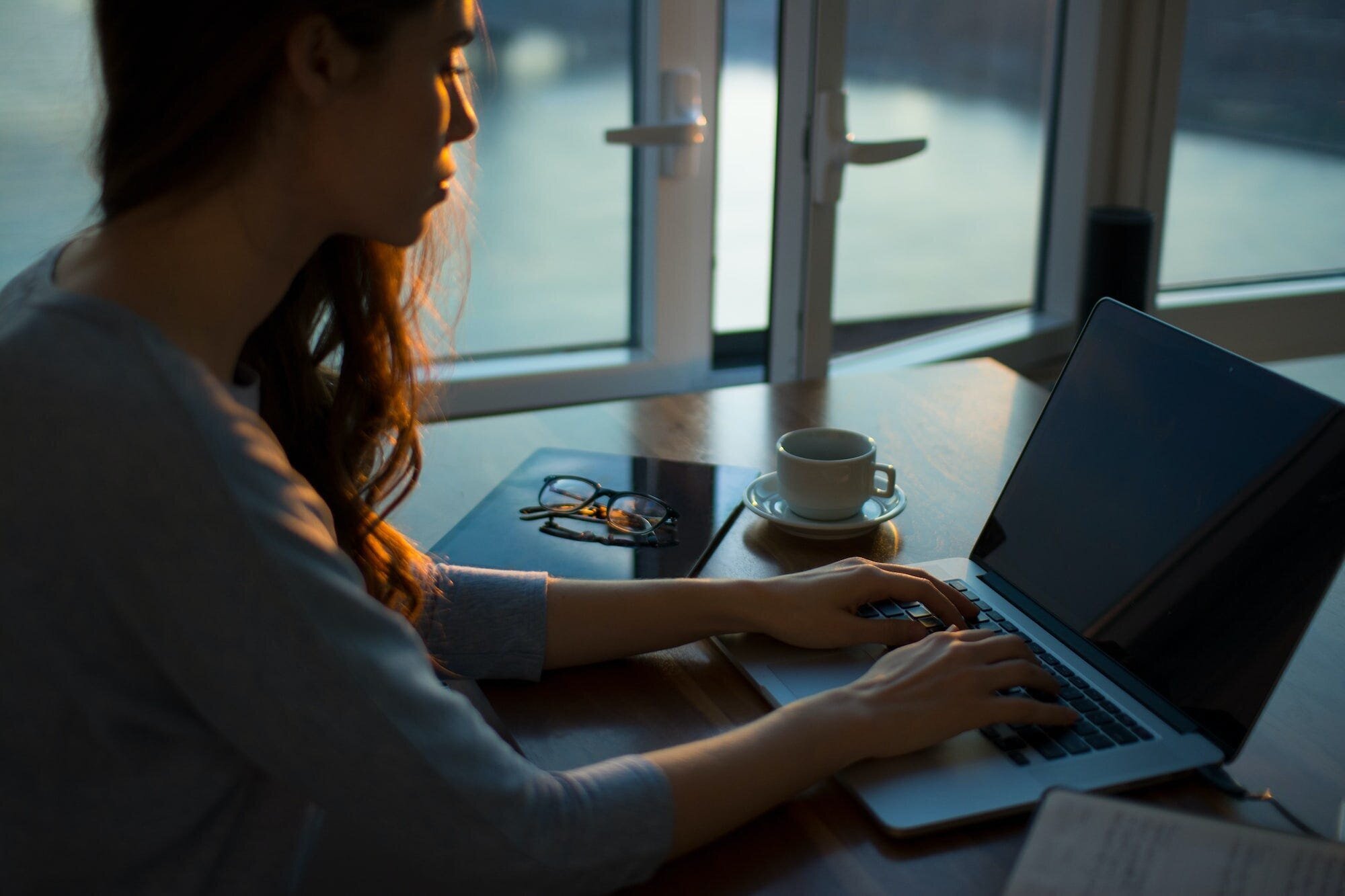 Remotasks Review: Everything You Need to Know About the Micro-Job Site for Remote Work Opportunities 4 | Mania Africa | maniainc.com A woman working on her laptop at dusk. We found that Remotasks pays too little