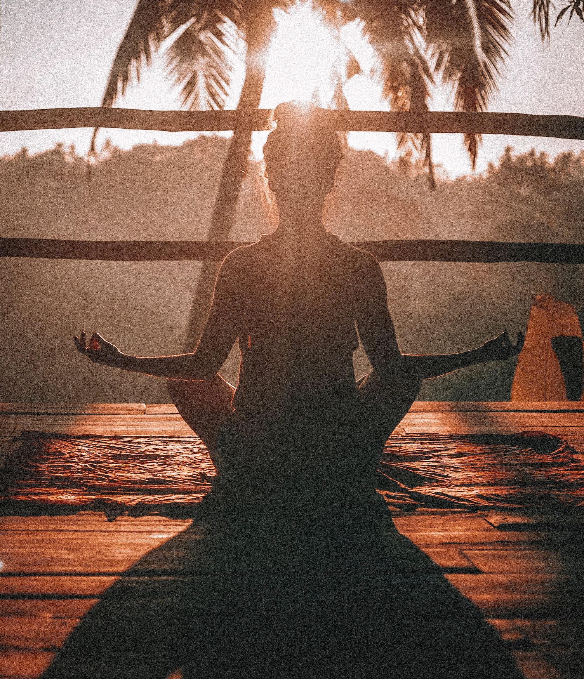 The Ultimate Guide to Meditation for Stress and Anxiety Relief 5 | Mania Africa | maniainc.com A woman undertaking a morning yoga session while peering into the jungle in Ubud, Bali.