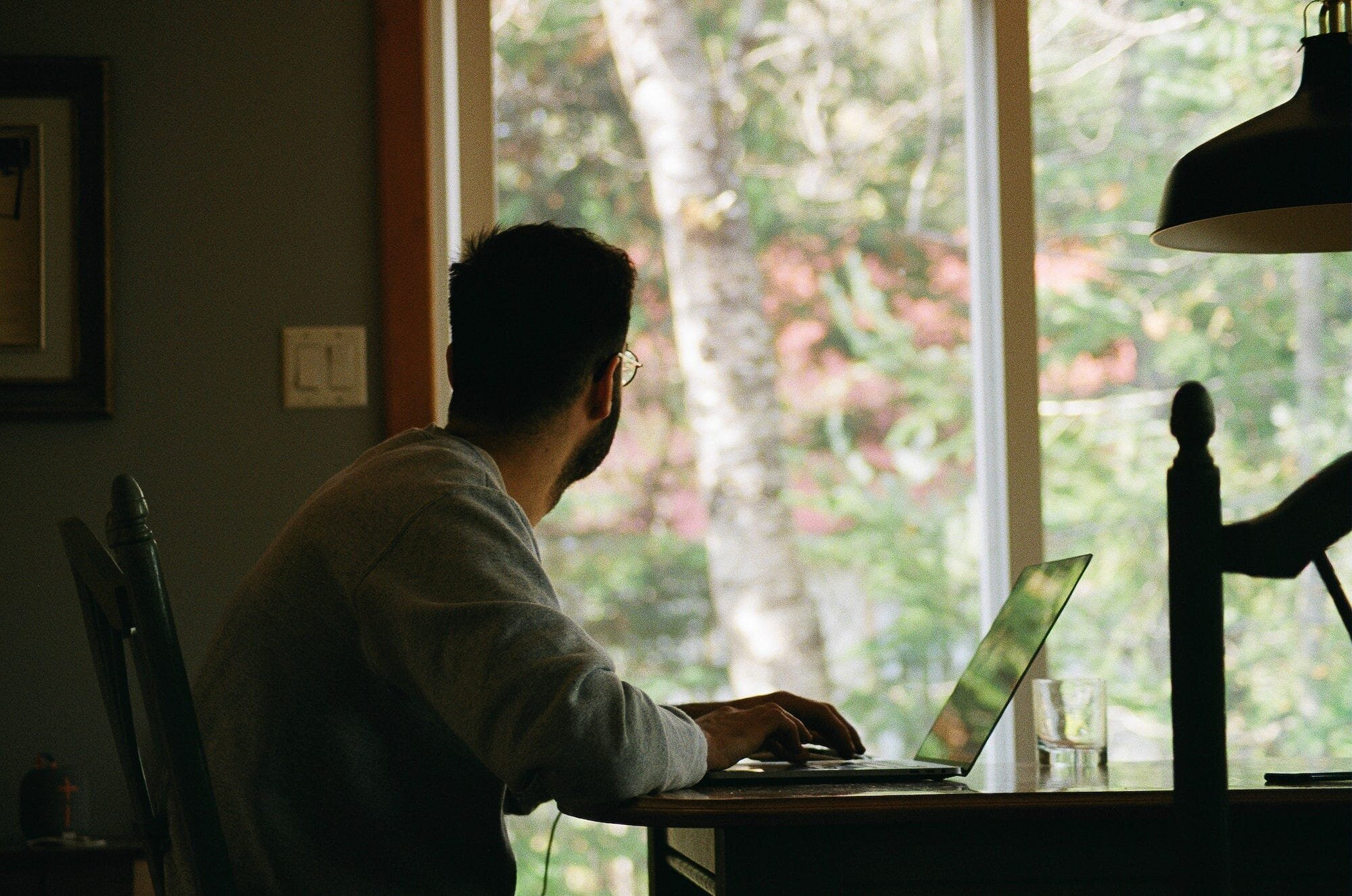 Remote Work: Benefits and Drawbacks for Employees and Employers 2 | Mania Africa | maniainc.com A man working from home looking outside