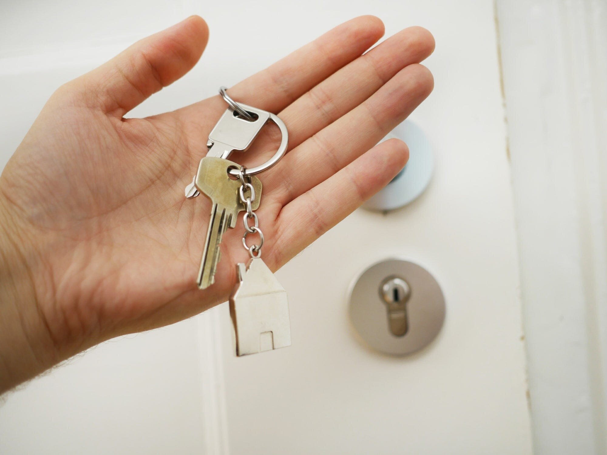 Personal Finance: Tips and Tricks for Managing Your Money 3 | Mania Africa | maniainc.com A set of keys on someone's palm with the door in the background