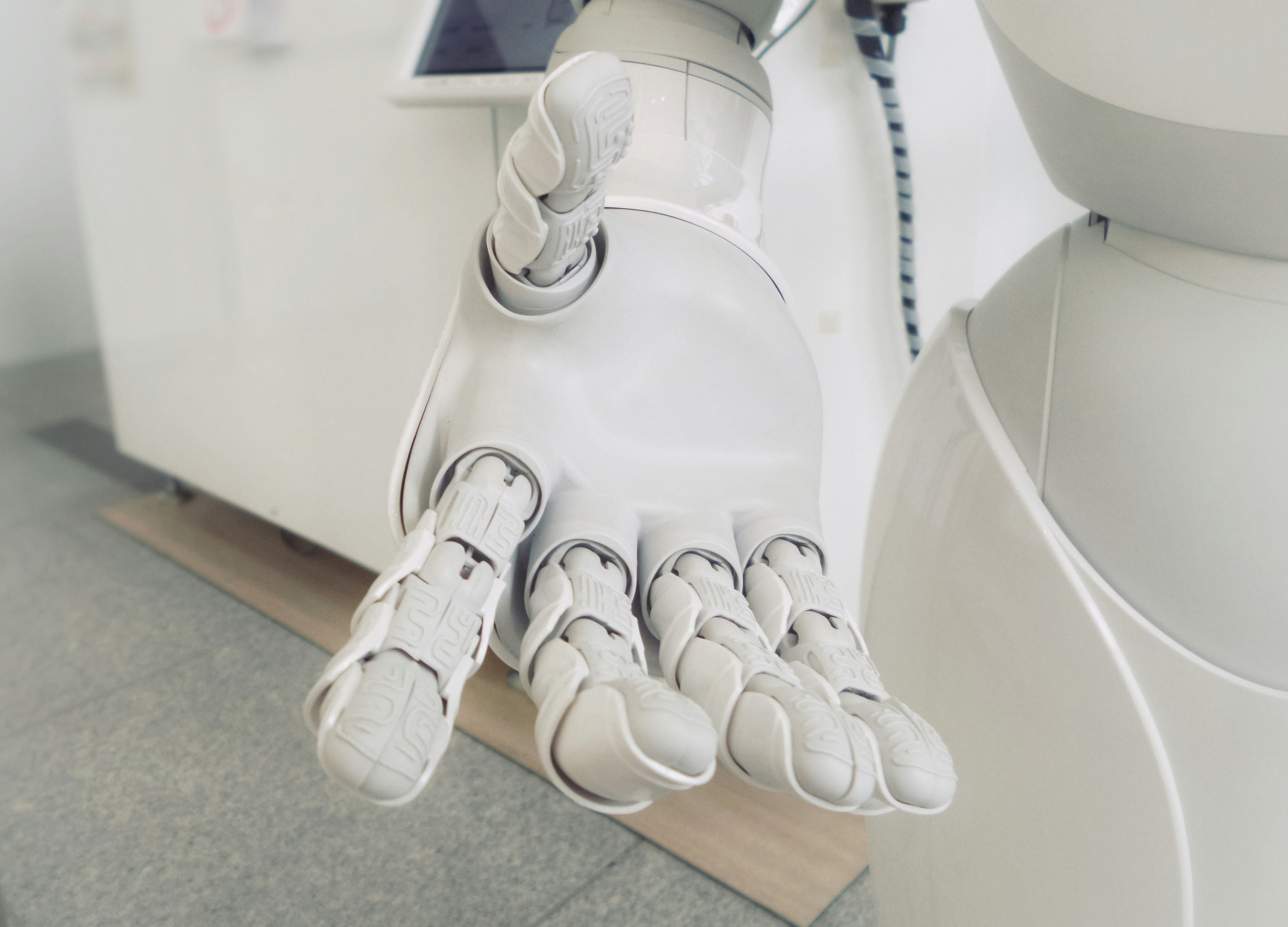 Middle-Income Trap, 3i Strategy closeup photo of white robot arm | Breaking Free from Economic Stagnation: The 3i Strategy for High-Income Status | Mania Finance