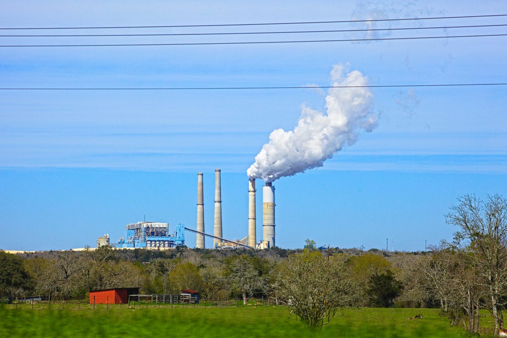 Middle-Income Trap, 3i Strategy white smoke coming out from factory | The Global Implications of the Middle-Income Trap | Mania Africa
