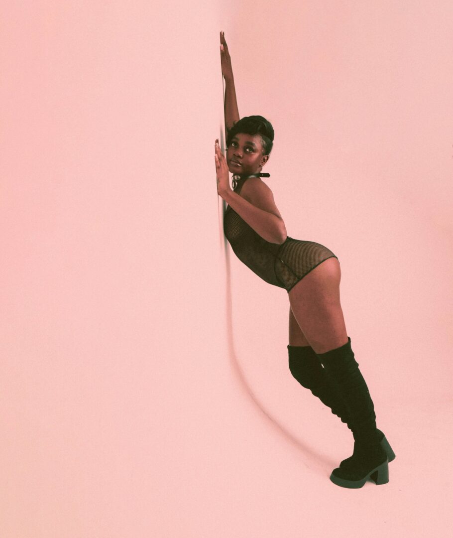 The Sex Diaries #3: How to Get What You Like During Sex 7 | Mania Africa | maniainc.com a woman in a short skirt and knee high boots leaning against a wall