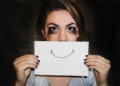 A person holding white printer paper. Overcoming Burnout: Rediscovering Joy in Your Work - Mania Work
