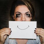 A person holding white printer paper. Overcoming Burnout: Rediscovering Joy in Your Work - Mania Work