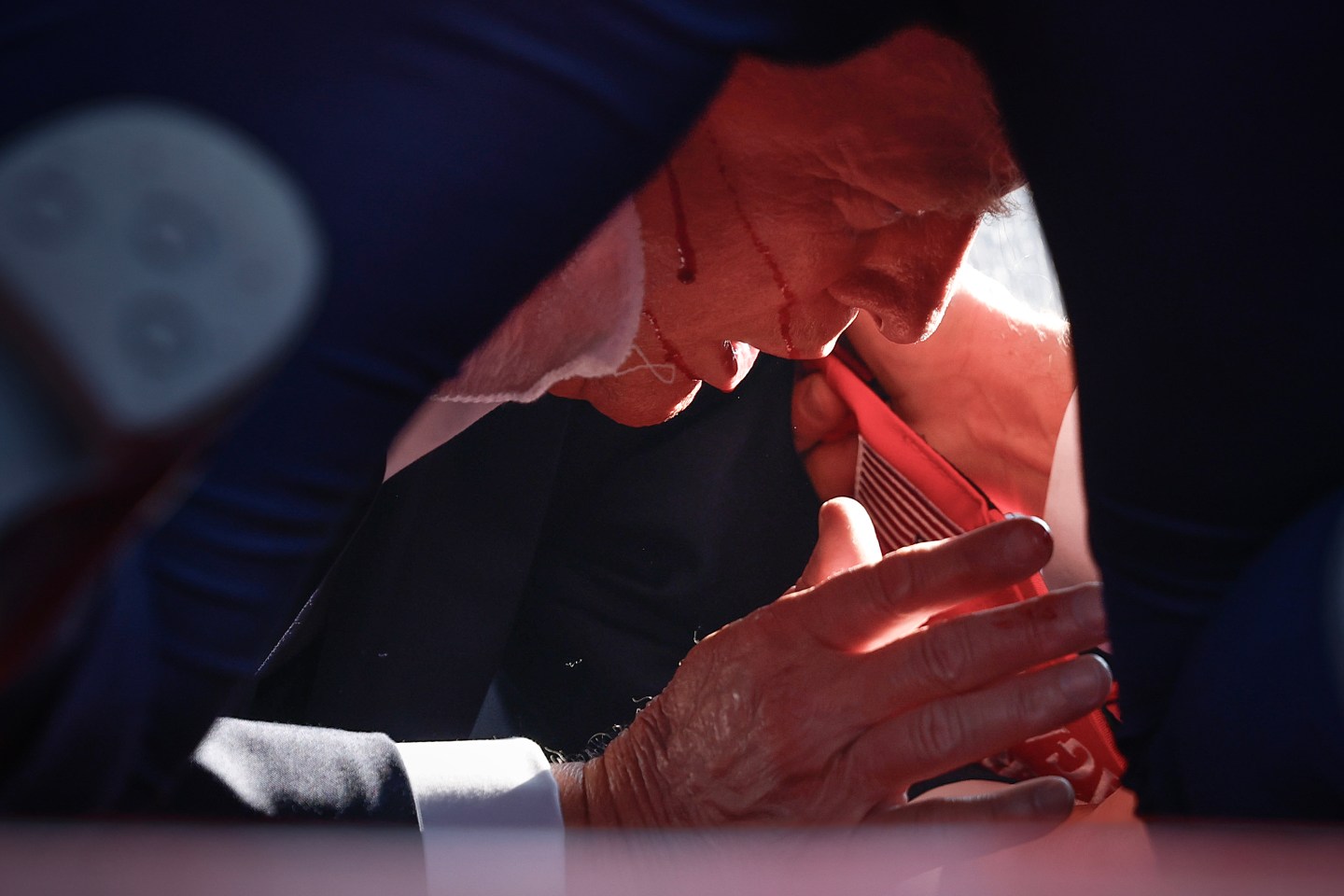 Trump Shot: Inside Foiled Trump Assassination Attempt 2 | Mania Africa | maniainc.com A photo of Trump taking cover moments after being shot | Trump Shot | Mania Africa