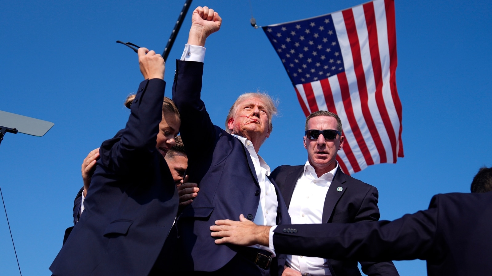 Trump Shot: Inside Foiled Trump Assassination Attempt 3 | Mania Africa | maniainc.com Former President Donald Trump raises his right fist in defiance after a foiled assassination attempt against him | Trump Assassination Attempt | Mania News