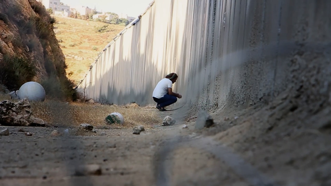 How Jews in the Diaspora View the Israeli-Palestinian War: A Documentary's Revelations 3 | Mania Africa | maniainc.com A Palestinian at the wall demarcating Israel and Gaza | How Jews in the Diaspora View the Israeli-Palestinian War: A Documentary