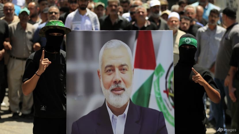 Middle-East War Looms: Israel Kills Hamas Leader Ismail Haniyeh and Hezbollah Commander 6 | Mania Africa | maniainc.com Hamas militants carrying the portrait of Haniyeh | Crisis in the Middle East: Tensions Escalate Amid Fears of All-Out War | Mania News