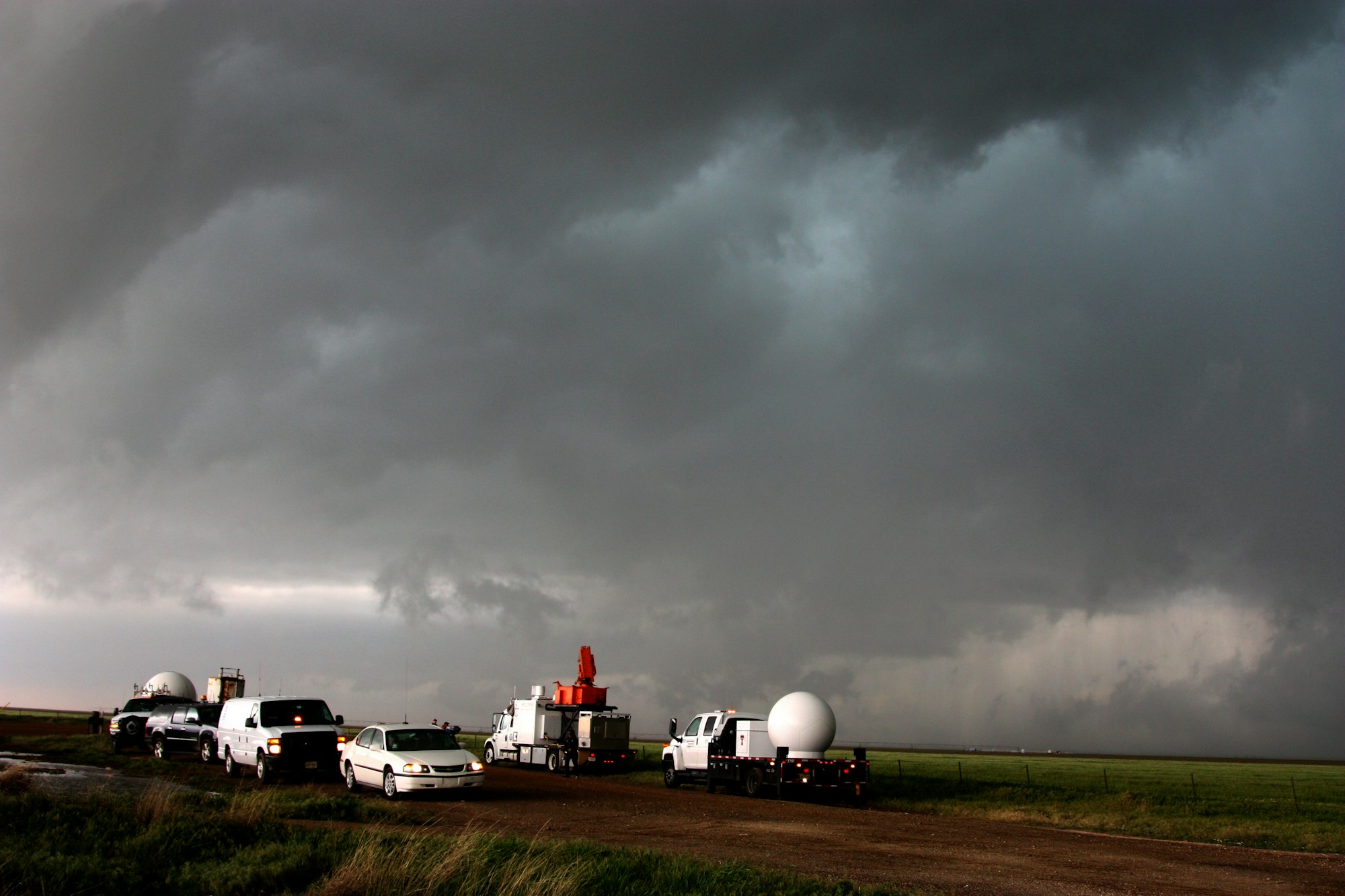 The Urgent Realities of Climate Change: Facts and Solutions for a Sustainable Future 11 | Mania Africa | maniainc.com A fleet of VORTEX2 vehicles tracks a supercell thunderstorm near Dumas. The blue-green color in the cloud is associated with large hail.