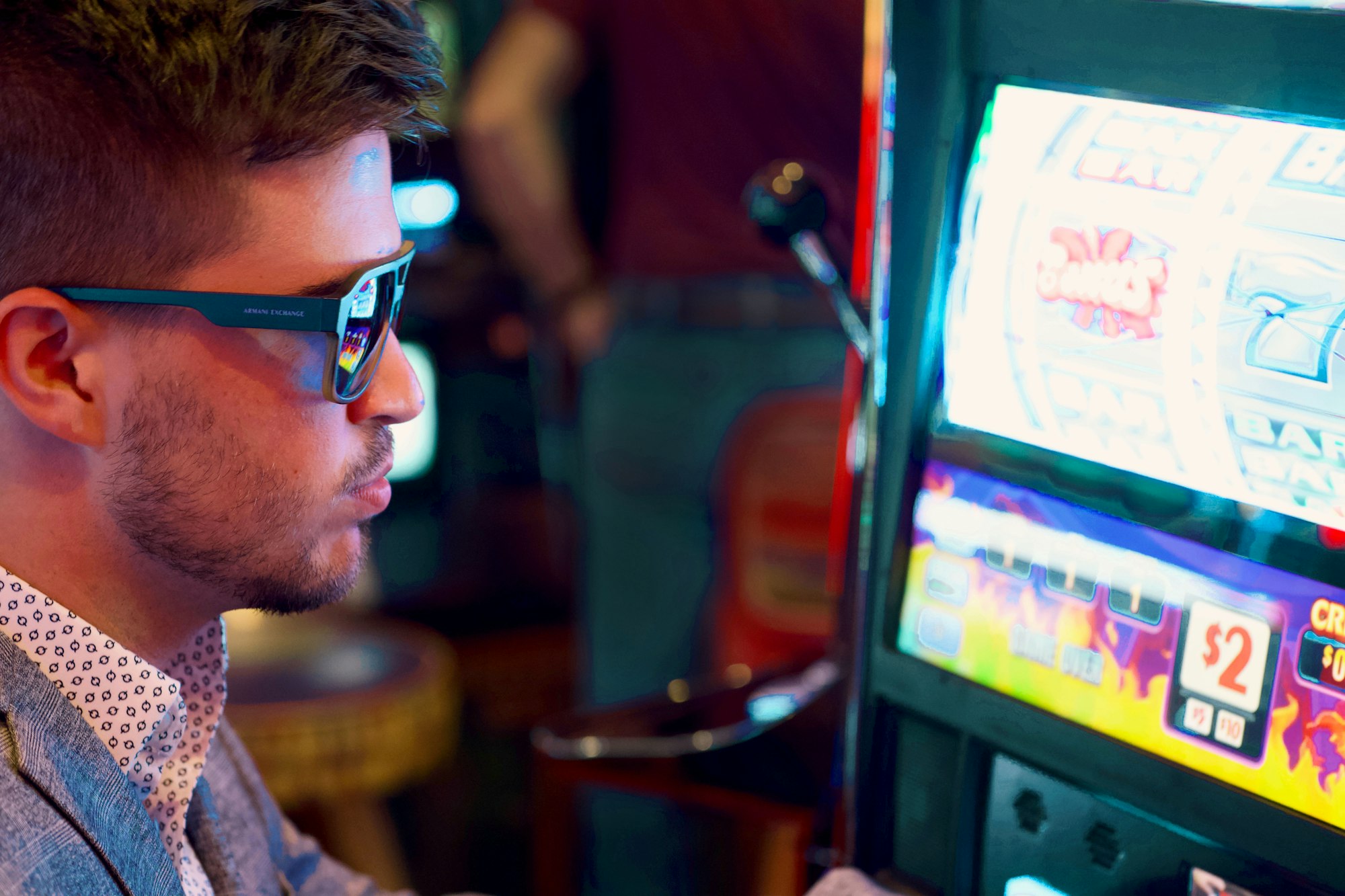 The Hidden Costs of Europe's Digital Gambling Explosion: Addiction, Exploitation, and the Quest for Reforms 12 | Mania Africa | maniainc.com a man in glasses gambling in a casino | Characteristics of Problem Gambler Behavior | Featured Stories on Mania Africa