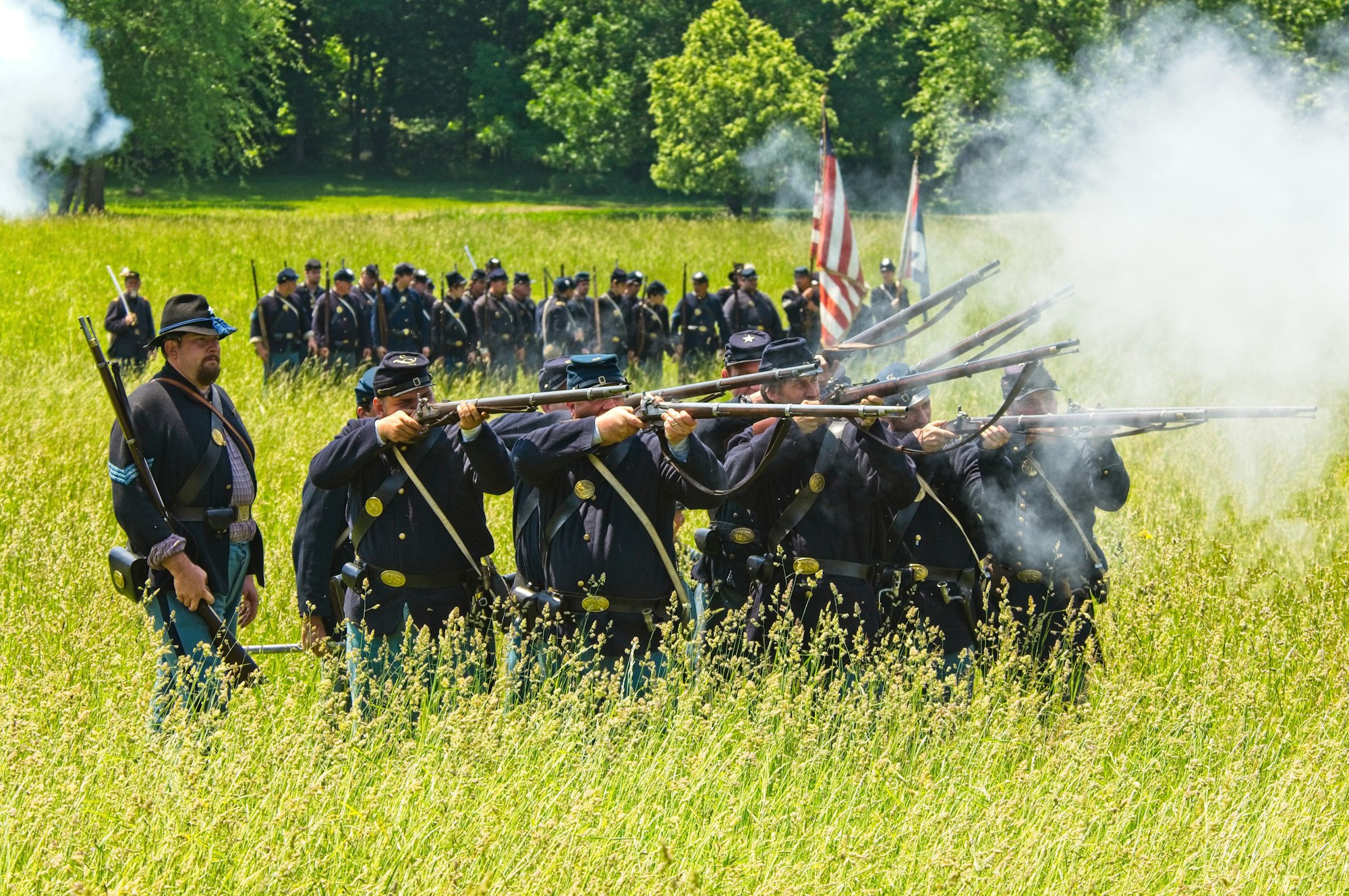 Conspiracy Theories and Extremism: Is a Civil War Looming in America? 21 | Mania Africa | maniainc.com People in black uniform standing on green grass field while fighting a civil war | A civil war in America could set the country back hundreds of years | Rise of the Militia: Is a Civil War Looming in America? | Mania Opinion